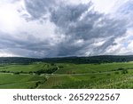 Dramatic Storm Clouds Over Vibrant Green Agricultural Fields