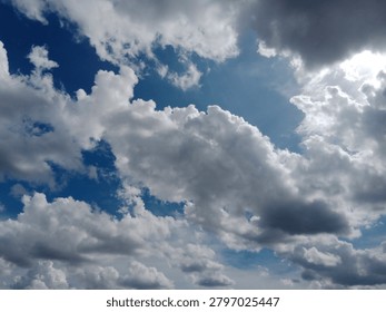 Dramatic storm clouds partially obscure the sun, creating striking light rays and contrast in the sky. Atmospheric weather scene symbolizing change, power, and nature.