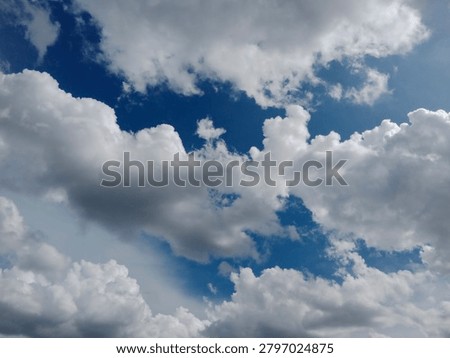 Dramatic storm clouds partially obscure the sun, creating striking light rays and contrast in the sky. Atmospheric weather scene symbolizing change, power, and nature.