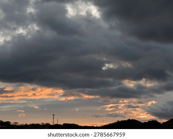 Dramatic Storm Clouds at Sunset over Silhouetted Hills