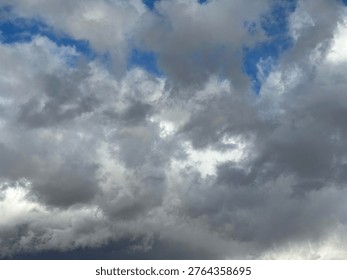 Dramatic storm clouds with visible rain shafts over open prairie landscape creating intense weather atmosphere and natural power scene