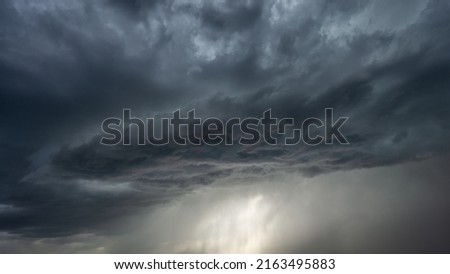 dramatic storm with stormy clouds and rain on sky
