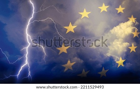 Dramatic stormy clouds with lightning next to EU stars flag symbol. Upcoming crisis and economy problems in Europe.