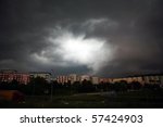 Dramatic stormy clouds over row of houses