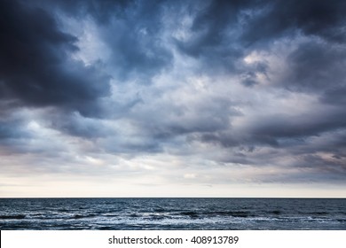 Dramatic stormy dark cloudy sky over sea, natural photo background - Shutterstock ID 408913789