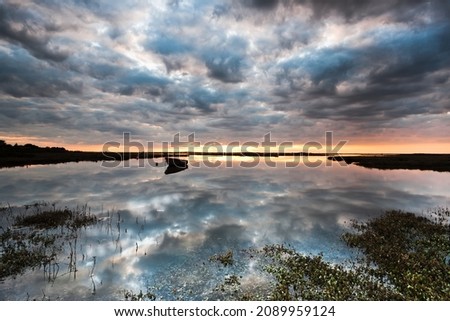 A dramatic stormy evening sky over the saltmarshes at Burnham Deepdale on the nortyh Norfolk coast