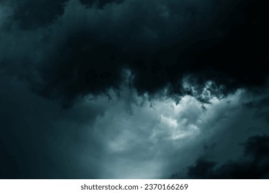 Dramatic stormy sky background. Dark green fluffy cloudy sky. Halloween cloudscape background concept. 