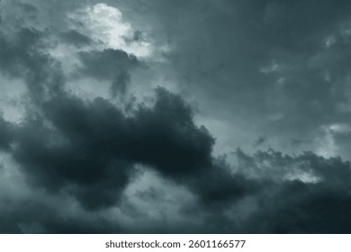 Dramatic stormy sky background. Dark fluffy cloudy sky. Moody spooky cloudscape. Rainy season.