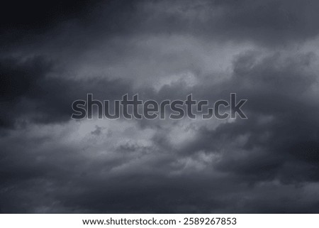 Dramatic stormy sky background. Dark fluffy cloudy sky. Halloween cloudscape background concept.