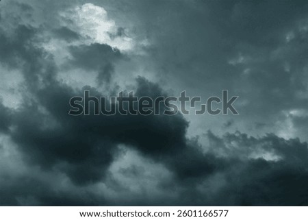 Dramatic stormy sky background. Dark fluffy cloudy sky. Moody spooky cloudscape. Rainy season.