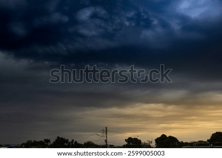 Dramatic stormy sky with dark clouds over the road.