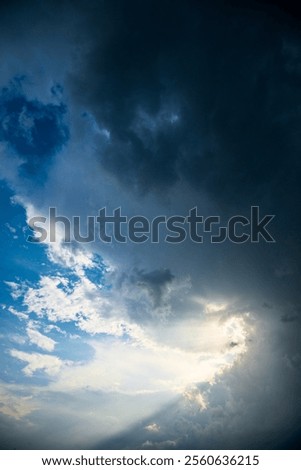 Dramatic stormy sky with rays of sunshine
