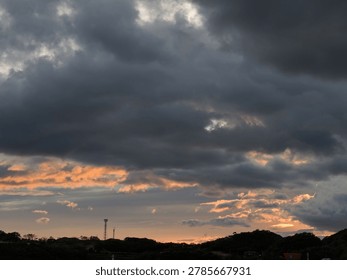 Dramatic Stormy Sky at Sunset over Silhouetted Hills