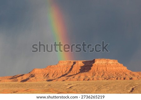 Dramatic stormy sky's over butte with rainbow in Valley of the Gods in Utah