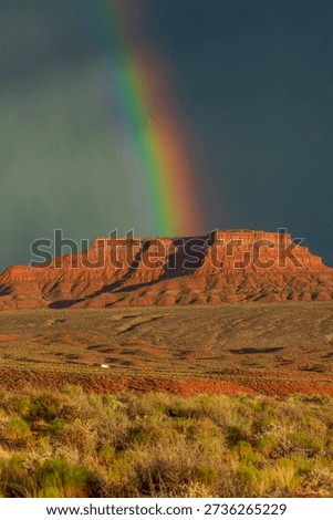 Dramatic stormy sky's over butte with rainbow in Valley of the Gods in Utah