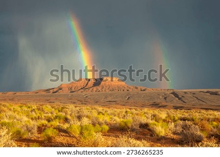 Dramatic stormy sky's over butte with rainbow in Valley of the Gods in Utah