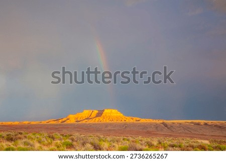 Dramatic stormy sky's over butte with rainbow in Valley of the Gods in Utah