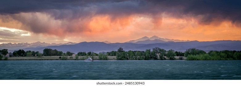 dramatic, stormy sunset with high wind over Longs Peak and Front Range of Rocky Mountains in northern Colorado