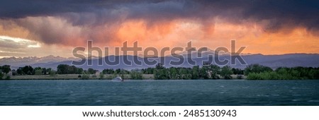 dramatic, stormy sunset with high wind over Longs Peak and Front Range of Rocky Mountains in northern Colorado