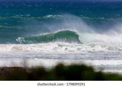 dramatic stormy wave breaking on the beach