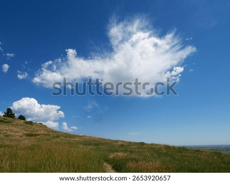 Dramatic Summer Clouds over Grassy Slopes of Hogback Ridge Trail, Boulder, Colorado