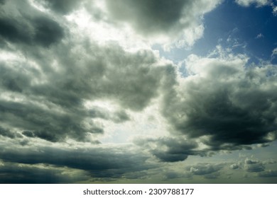 Dramatic summer clouds seen within around 30 minutes of a thunderstorm with torrential rain. The sky has a slight green cast due to the coming storm. 