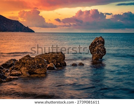 Dramatic summer scene of Palinuro with dramatic clouds. Majestic morning view of cliffs near Natural Arch of Palinuro, Italy, Europe. Fabulous sunrise on Mediterranean sea.