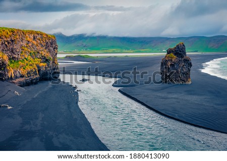 Dramatic summer scenery. Gloomy summer view of nature reserve - Reynisfjara Beach, Vik location, Iceland, Europe. Amazing seascape of Atlantic ocean with black sand beach.