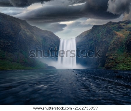 Dramatic summer scenery. Gloomy summer view of Skogafoss Waterfall. Gorgeous morning scene of Skoga river. Amazing landscape of Iceland, Europe. Beauty of nature concept background.