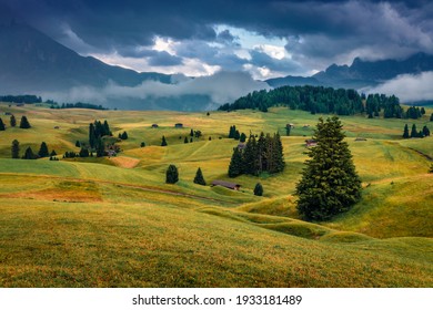 Dramatic summer scenery. Low overcast view of Compaccio village, Seiser Alm or Alpe di Siusi location, Bolzano province, Dolomite Alps, South Tyrol, Italy, Europe. Traveling concept background.