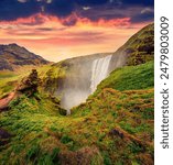 Dramatic summer sunrise on Skogafoss Waterfall. Fabulous morning landscape of Skoga river. Gorgeous outdoor scene of Iceland, Europe. Beauty of nature concept background.