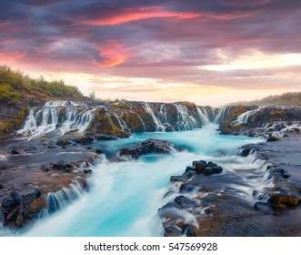 Dramatic summer sunset with unique waterfall - Bruarfoss. Colorful evening scene in South Iceland, Europe. Artistic style post processed photo.