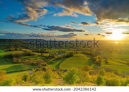 Dramatic summer sunset with views across the Severn valley from Coaley Peak nature reserve near Uley, The Cotswolds, Gloucestershire, UK