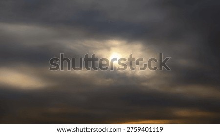 Dramatic Sun Breaking Through Storm Clouds

Powerful dramatic sky with the bright sun shining through thick dark storm clouds. Intense crepuscular rays pierce the heavy cloud layer creating a moody and atmospheric scene. Golden light contrasts with the dark overcast sky in this striking cloudscape at sunrise or sunset.