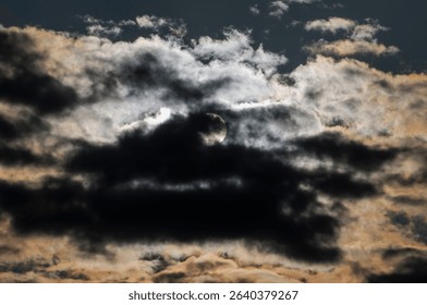 Dramatic Sun Hidden by Dark, Overcast Clouds
