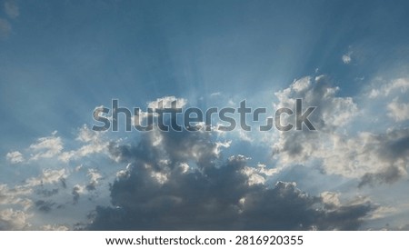 Dramatic Sun Rays Breaking Through Clouds in Blue Sky, Crepuscular Sunbeams Light Beam Background, Hope and Divine Light Concept.