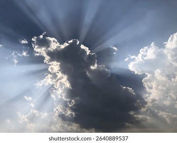 Dramatic Sun Rays Piercing Through Dark Storm Clouds in the Sky