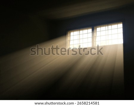 Dramatic sun rays piercing through a window into a dark room, creating striking light and shadow. Ideal for themes of hope, mystery, interior atmosphere, or spirituality.