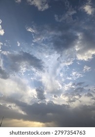 
Dramatic sun rays shining through clouds in blue sky, god rays, crepuscular rays, weather, natural light, atmosphere, outdoor, no people`
