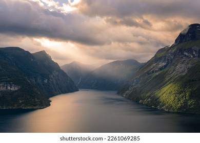 Dramatic sunbeam from the clouds over the Geirangerfjord, Norway