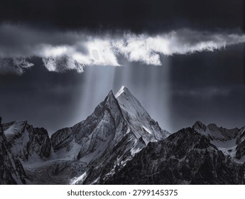 Dramatic Sunbeams Piercing Storm Clouds Over Snow-Covered Mountain Peak