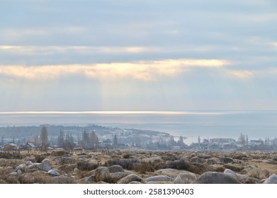 Dramatic Sunlight Breaking Through Clouds Above Issyk-Kul Lake in Kyrgyzstan