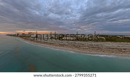 Dramatic Sunrise Aerial View: Juno Beach Coastline, Turquoise Ocean and Oceanfront Condos