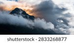 Dramatic sunrise cloudscape over the Chugach Mountains summit glacial rock formation in Anchorage Alaska viewed from Glen Alps Hiking Trail