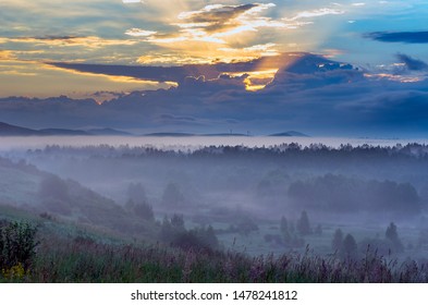 Dramatic Sunrise with Early Morning Mist over Forested Valley at Altai Mountains, Kazakhstan. Fantasyland, Blue Hour Concept.