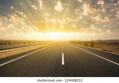 Dramatic Sunrise On Asphalt Road