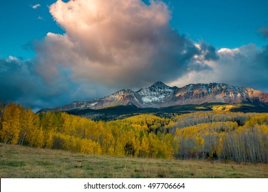 Dramatic Sunrise Over Snow Covered Wilson Peak Near Telluride With Golden Aspens In A Meadow