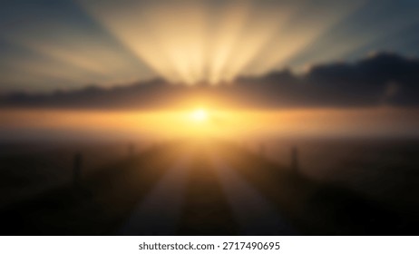 Dramatic sunrise with sun rays over a foggy field with creating a peaceful, and ethereal landscape.
