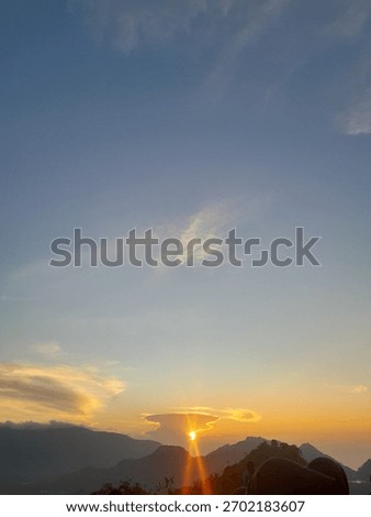 Dramatic sunrise or sunset captured from a mountaintop or high vantage point.