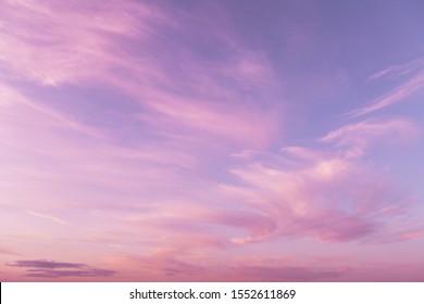 Dramatic sunrise, sunset pink violet sky with clouds background texture